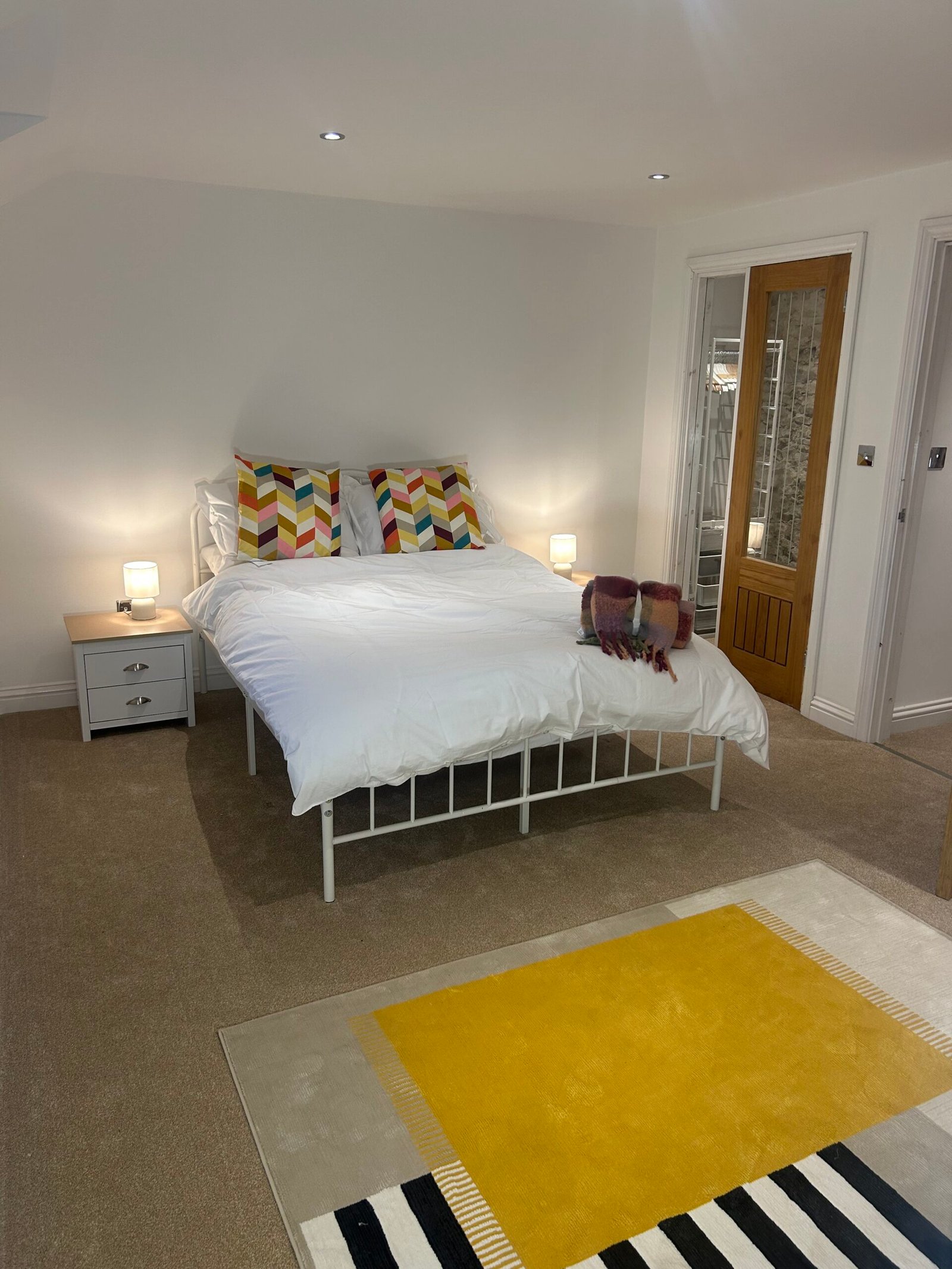 Master bedroom with king-size bed and walk-in wardrobe at Kielder Station Master's House