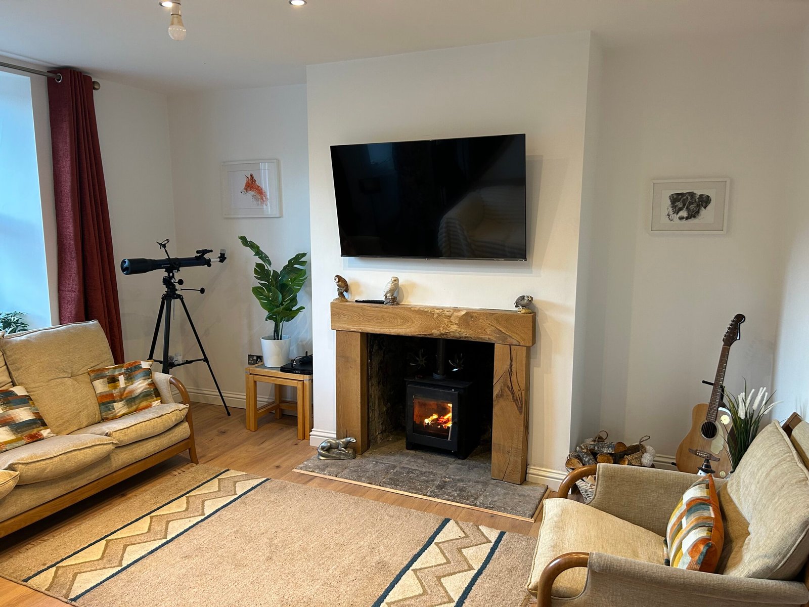 Lounge with lit log burner, smart TV and telescope